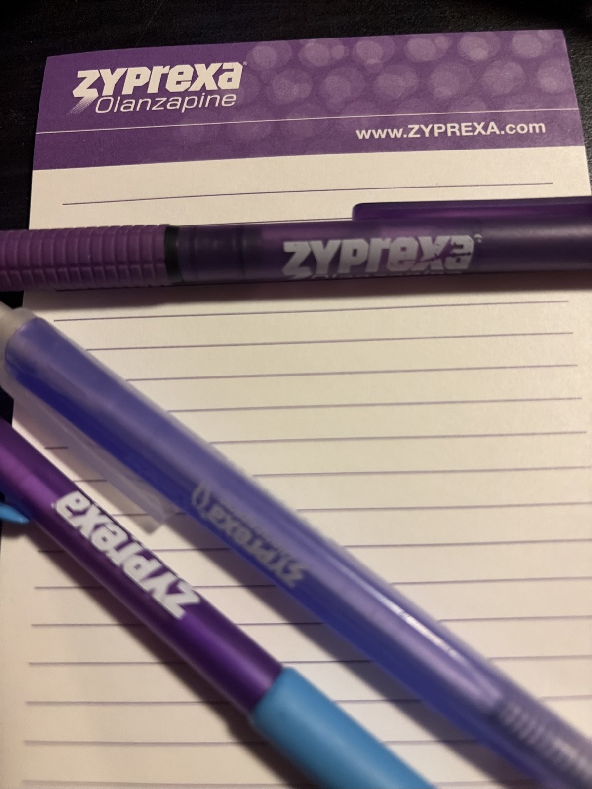 Zyprexa early 2000s collectible merch, 3 different pens, level, and mug