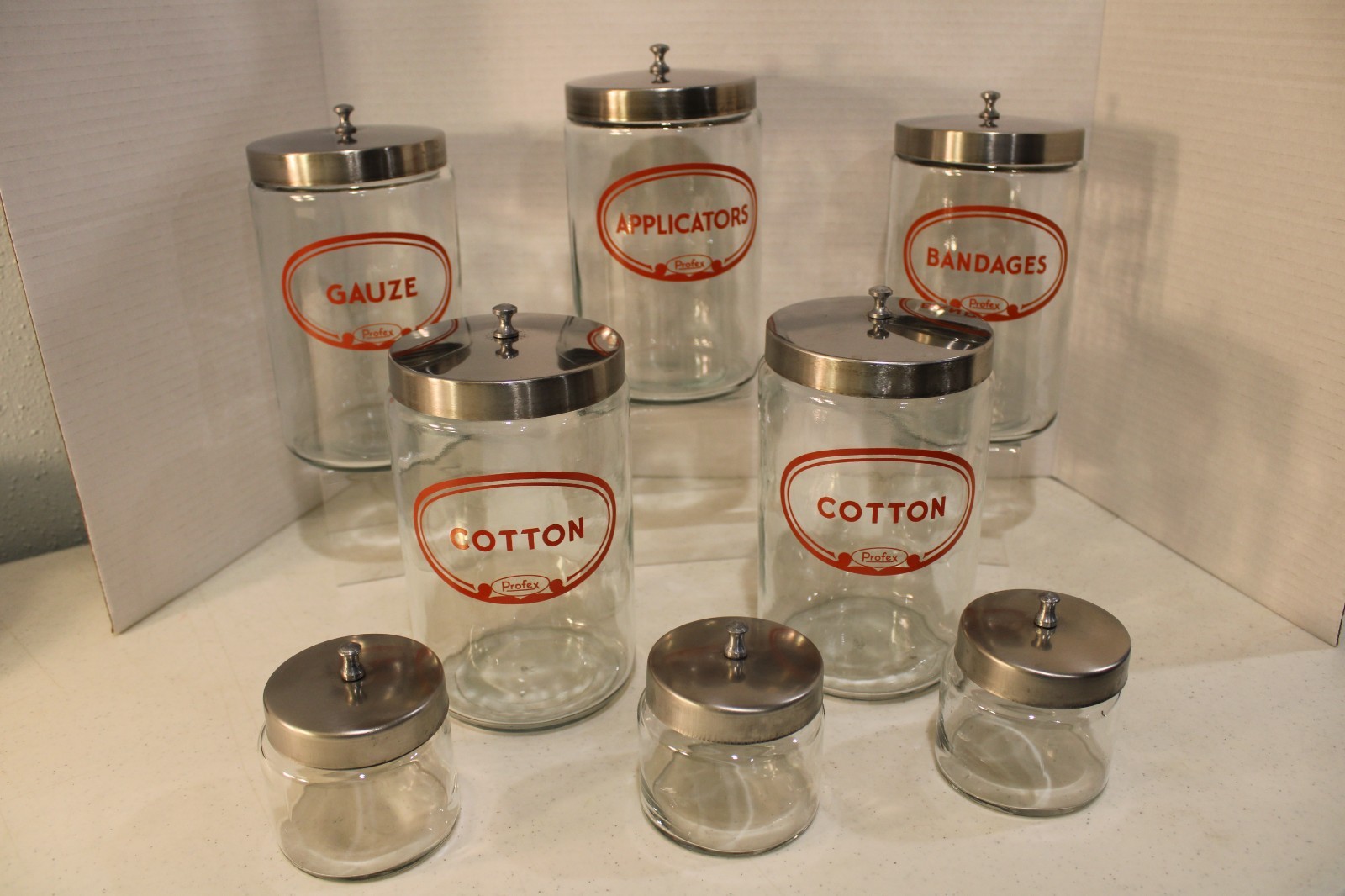VINTAGE SET OF PROFEX APOTHECARY JARS SET OF 8 7″ AND 3″ ORIGINAL LIDS NO DAMAGE