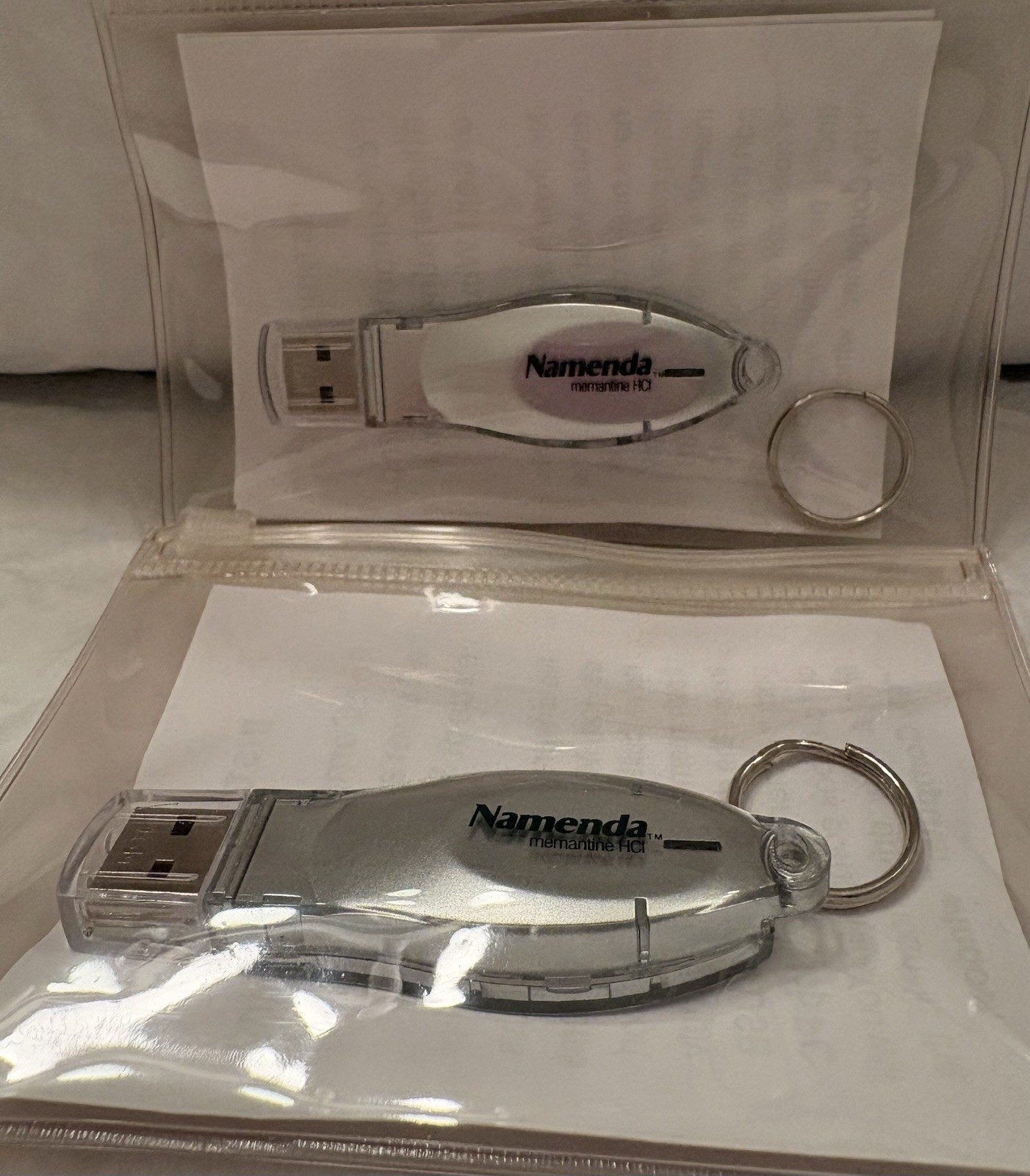 VTG LOT OF 2 NAMENDA USB FLASH MEMORY DEVICES + KEYRINGS PHARMA REP LOGO NEW