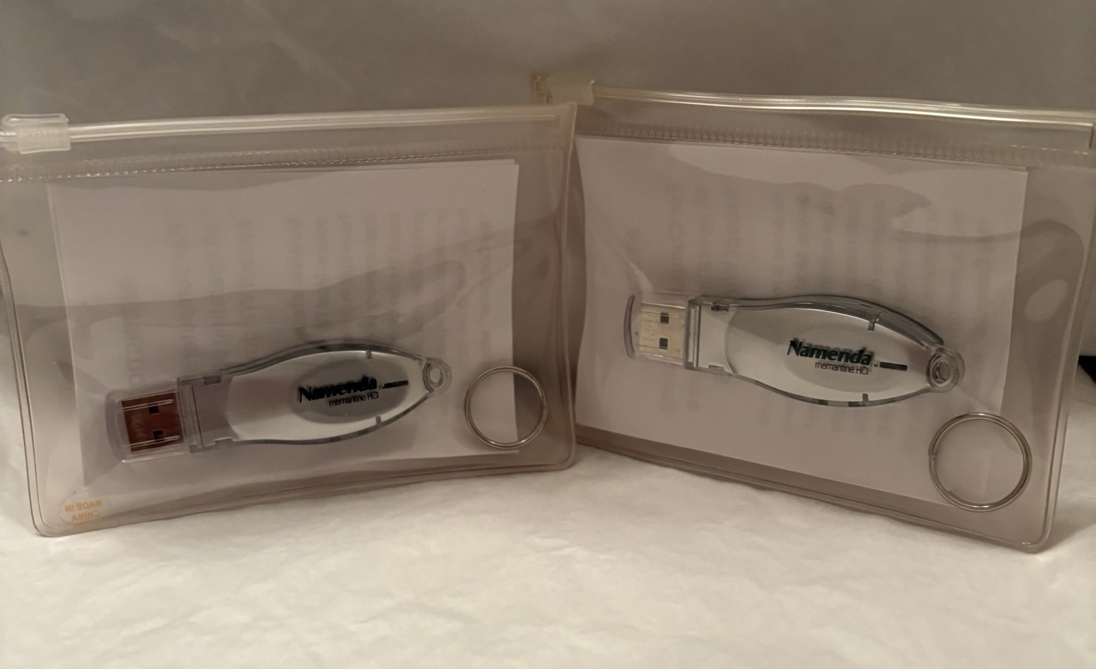 VTG LOT OF 2 NAMENDA USB FLASH MEMORY DEVICES + KEYRINGS PHARMA REP LOGO NEW