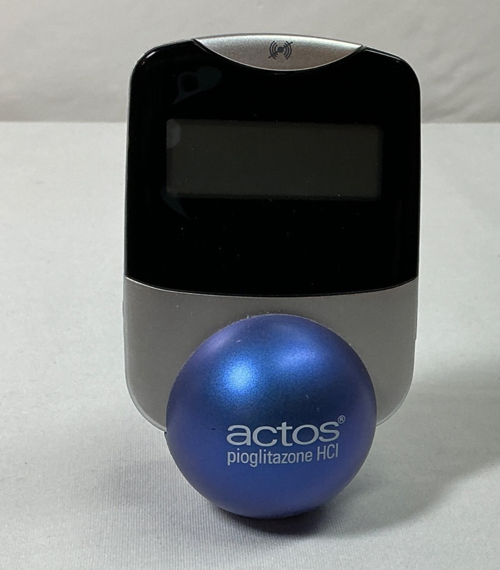 Actos Pharmaceutical Drug Rep Clock Balances On Ball, Works