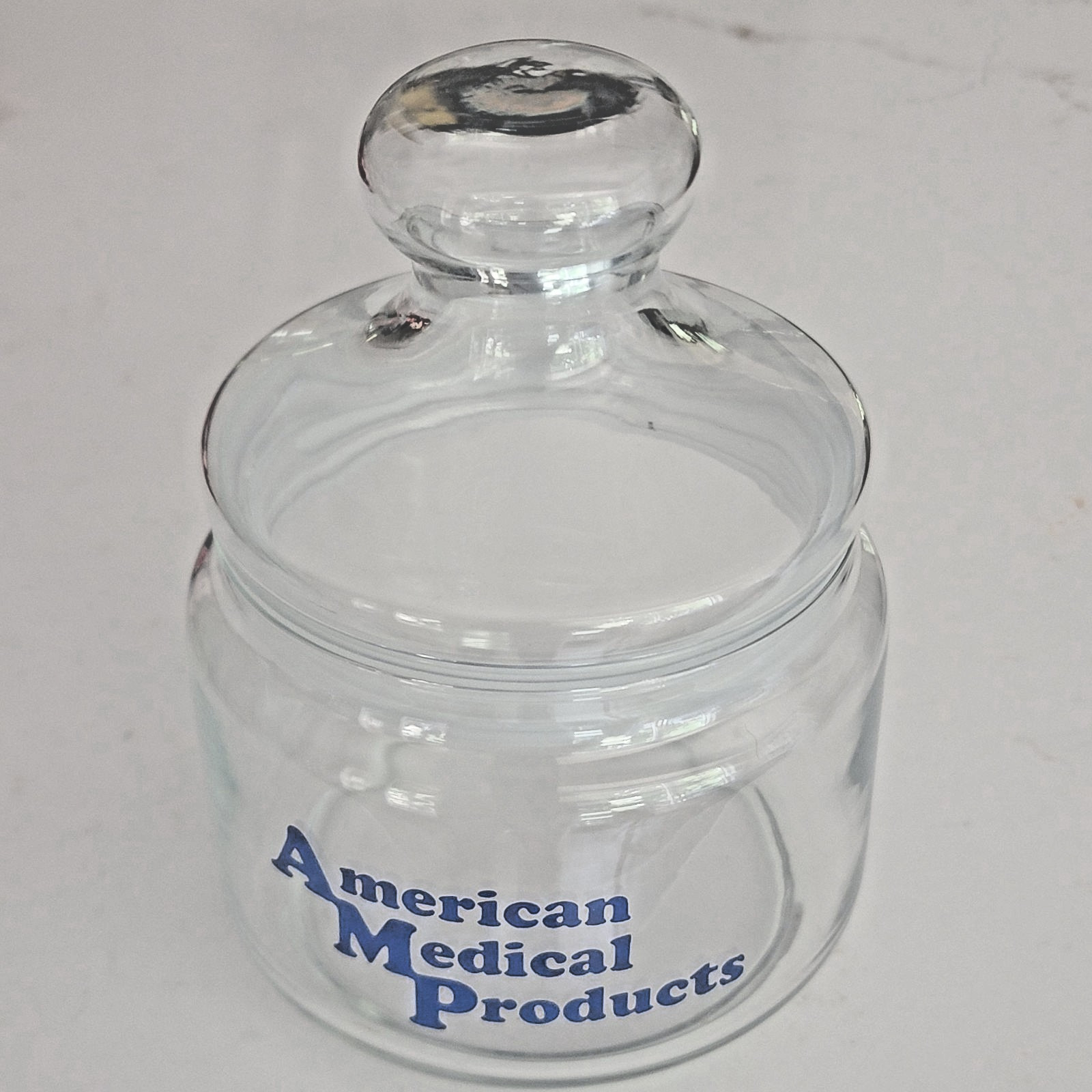 American Medical Products Clear Glass Jar Blue Writing 6″ VTG Retro