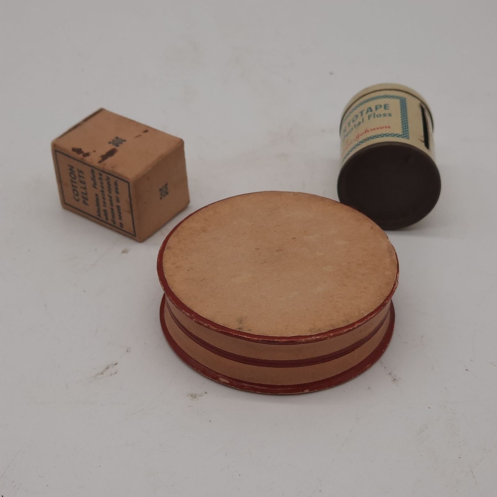 Vintage medicine cabinet packaging, cotton pellets, floss, lozenges, paper, meta