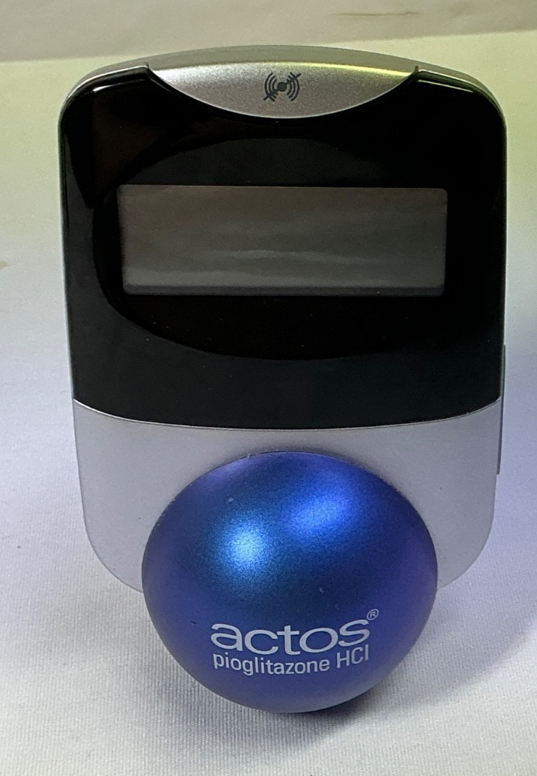 Actos Pharmaceutical Drug Rep Clock Balances On Ball, Works
